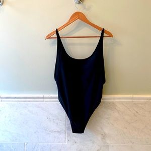 Black one piece open back swimsuit with gold detail